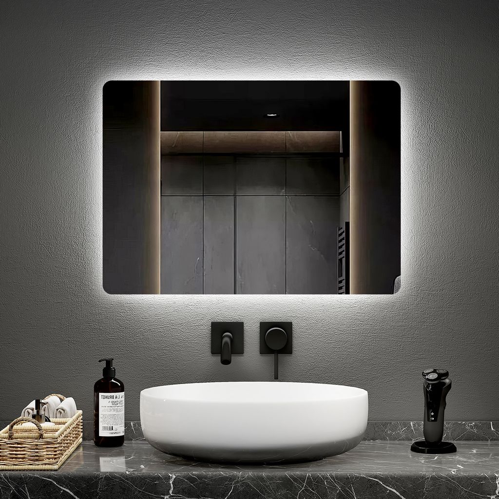 A modern bathroom vanity with a sink, faucet, and a lighted mirror.