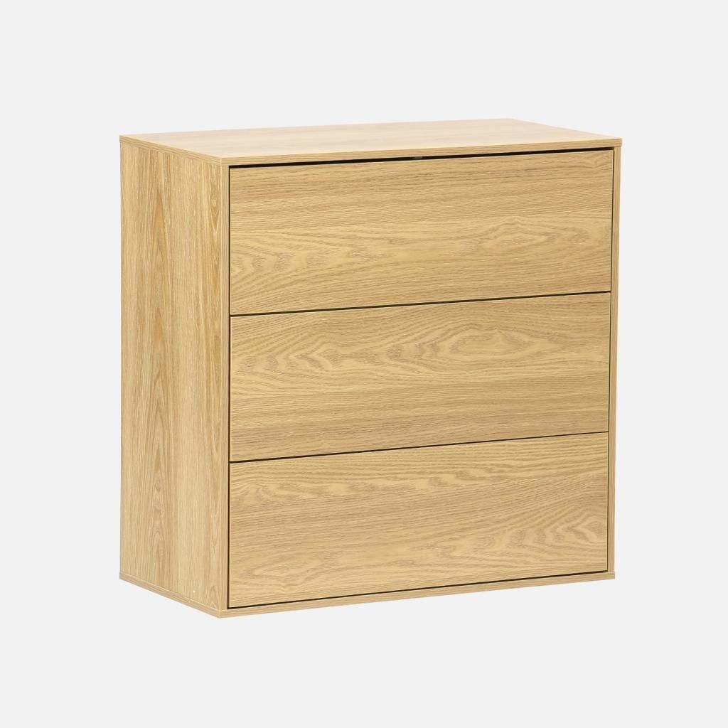 A three-drawer wooden chest of drawers against a plain background.