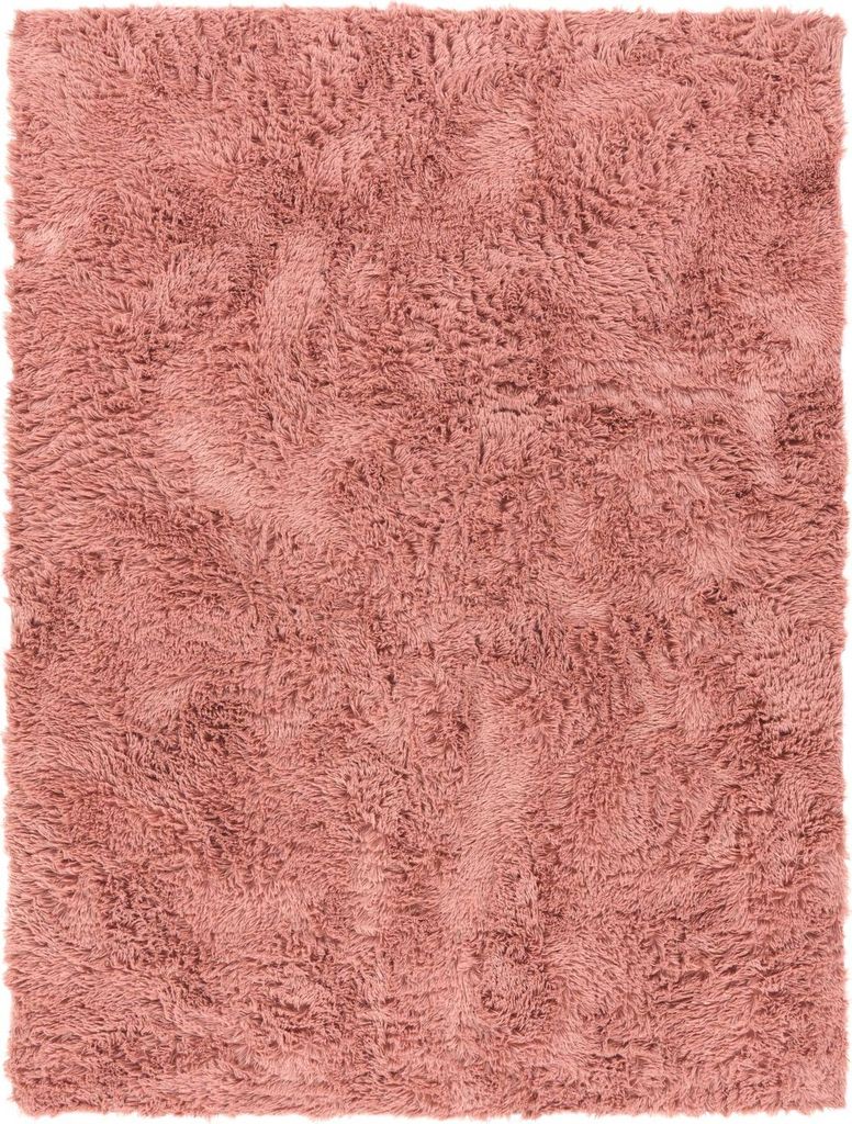 A close-up, top-down view of a pink shag rug.