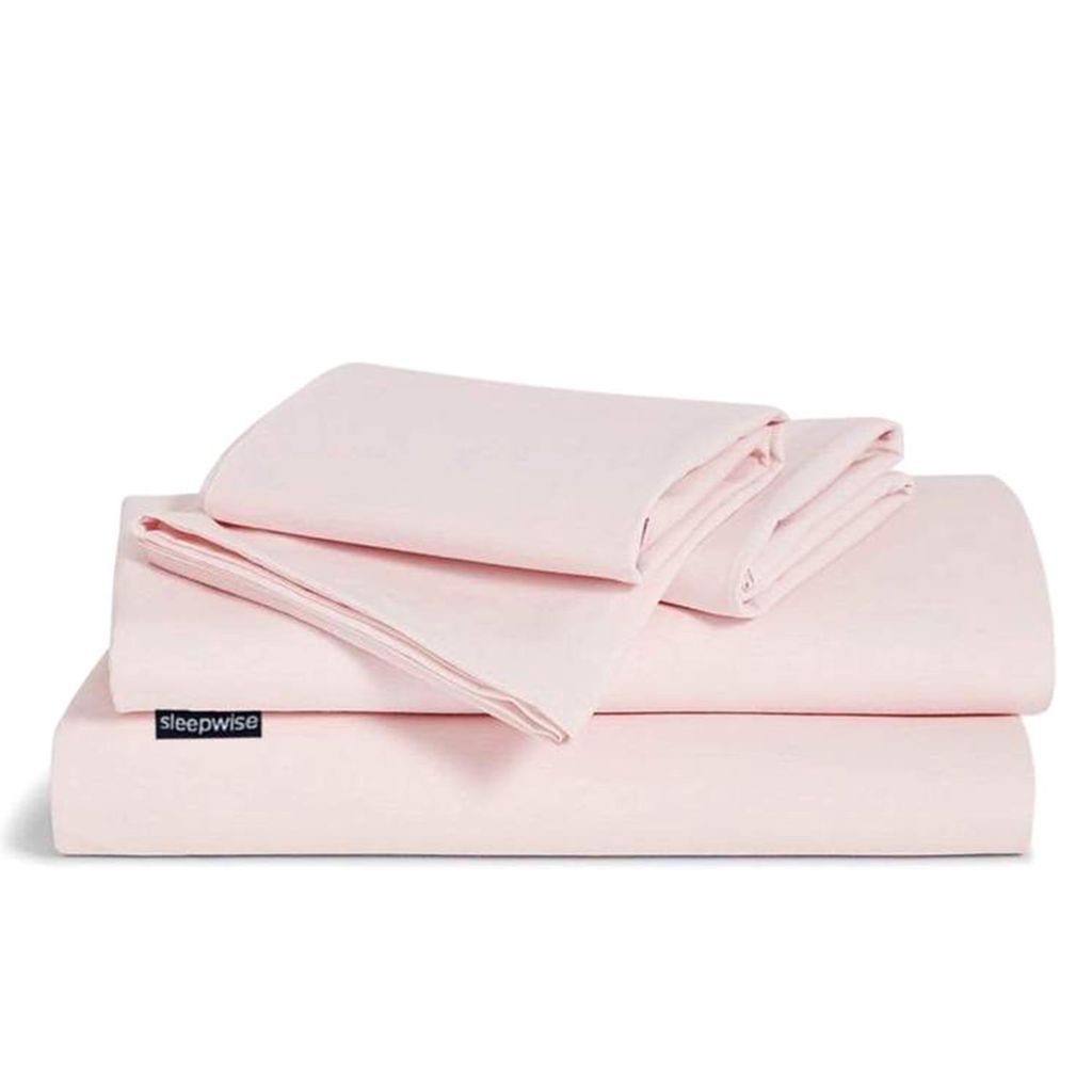 A stack of folded pink bedding items, including a duvet cover and pillowcase, is presented against a white background.