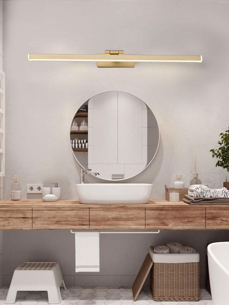 A modern bathroom vanity with a sink, mirror, and a light fixture above.