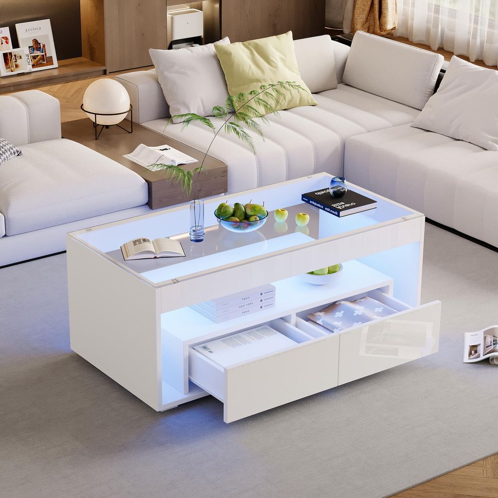 A modern living room with a white sectional sofa and a white LED coffee table.