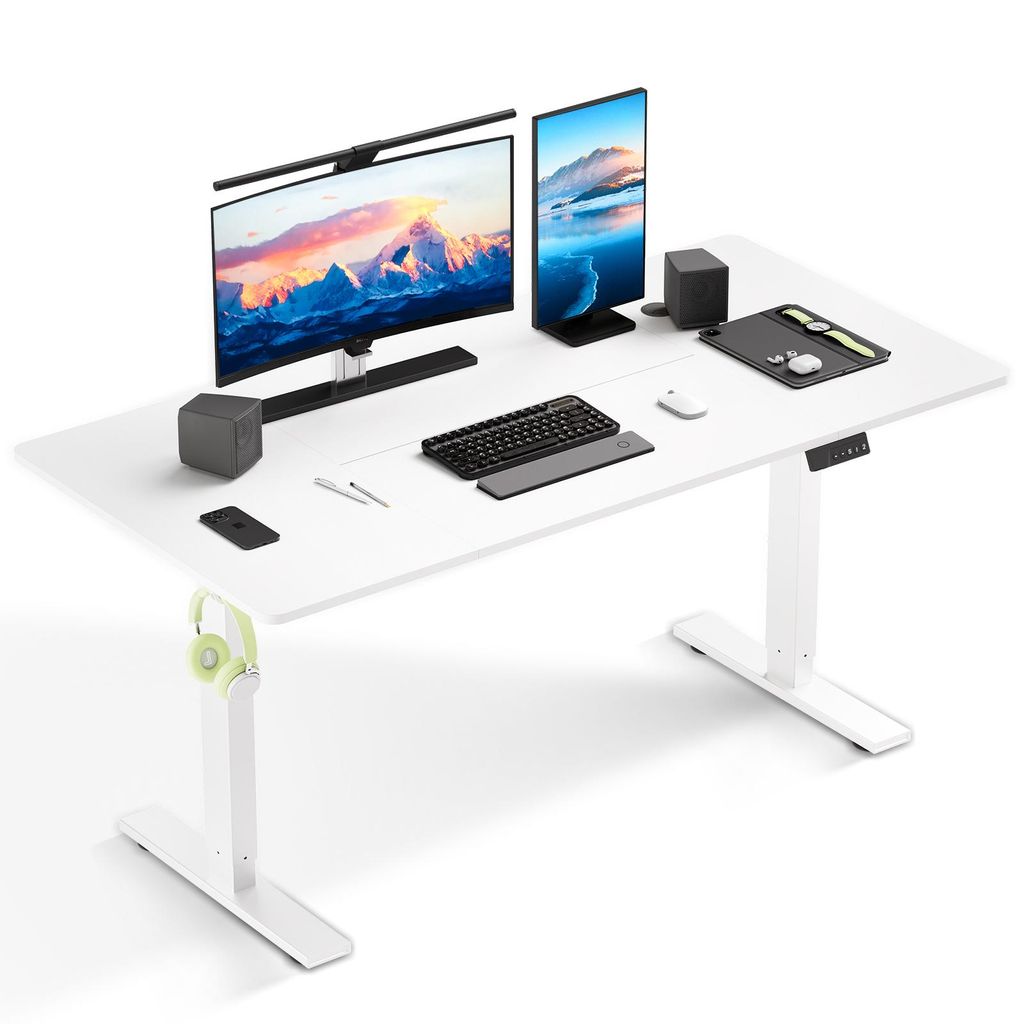 A white adjustable standing desk with two monitors, a keyboard, mouse, and other accessories.