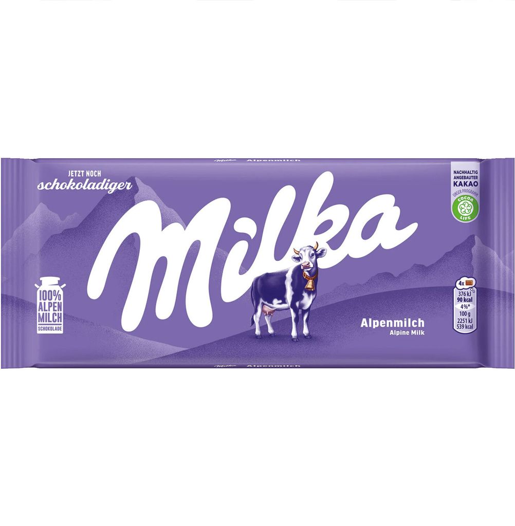 A Milka Alpine Milk chocolate bar with a cow illustration.