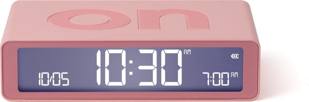 A pink digital alarm clock with a digital display showing the time.