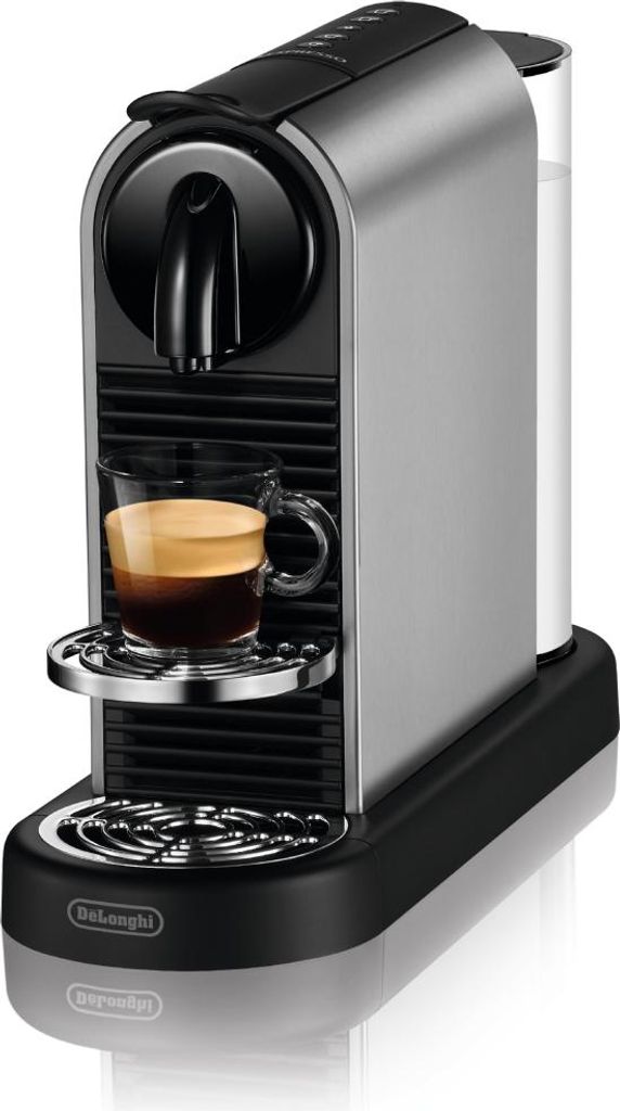 A silver and black Nespresso coffee machine with a cup of espresso.