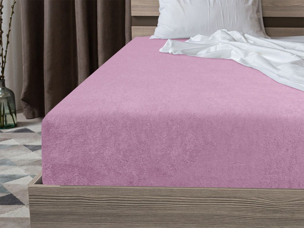 A pink fitted sheet on a bed.