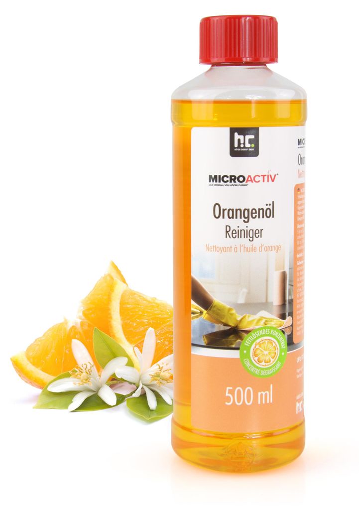 A bottle of orange oil cleaner with oranges and blossoms next to it.
