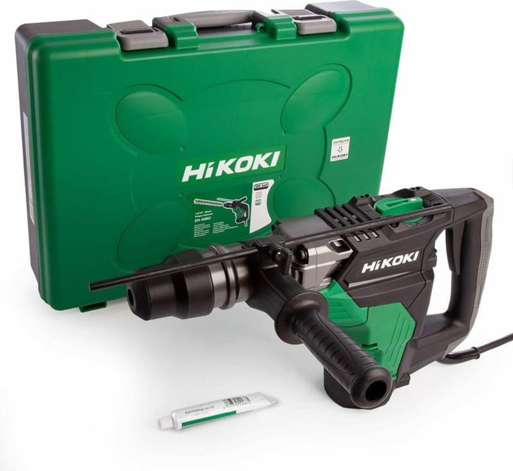 A rotary hammer drill and its carrying case are displayed on a white background, along with a small tube of lubricant.