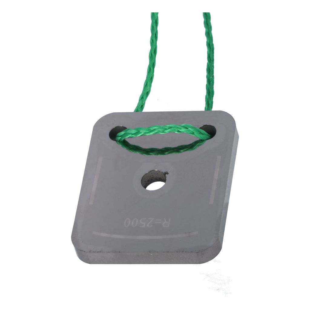 A close-up of a gray square object with a hole in the center, attached to a green string.