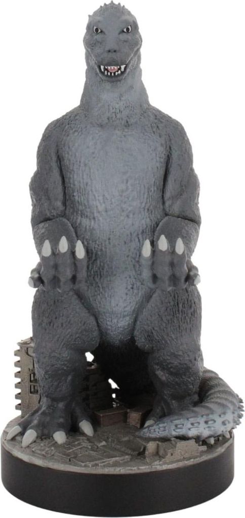 A Godzilla figurine standing on a base with some city debris.