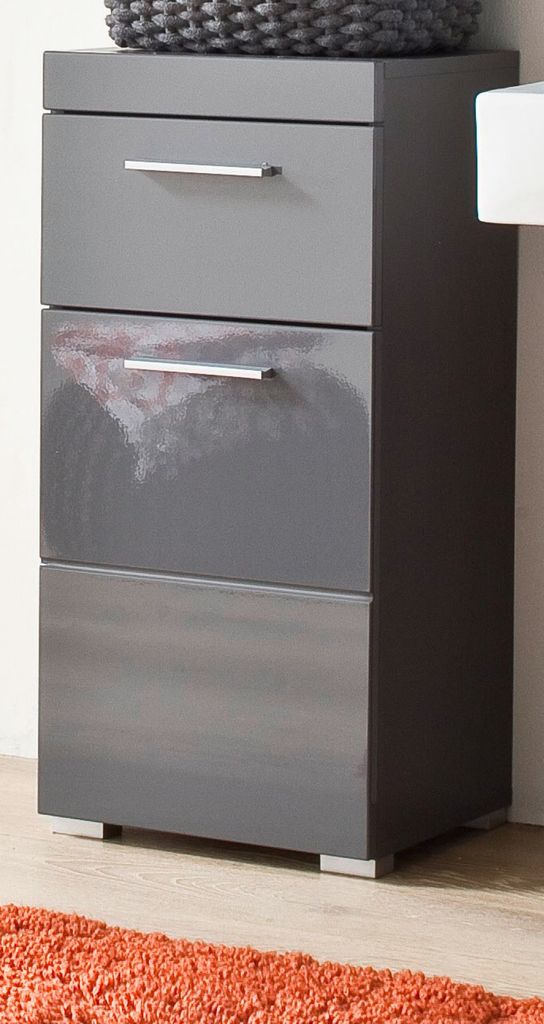 A close-up view of a gray, modern storage unit with three drawers.