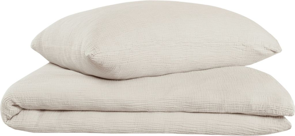 A folded duvet and a pillow, both in a light taupe color, are stacked on a white background.