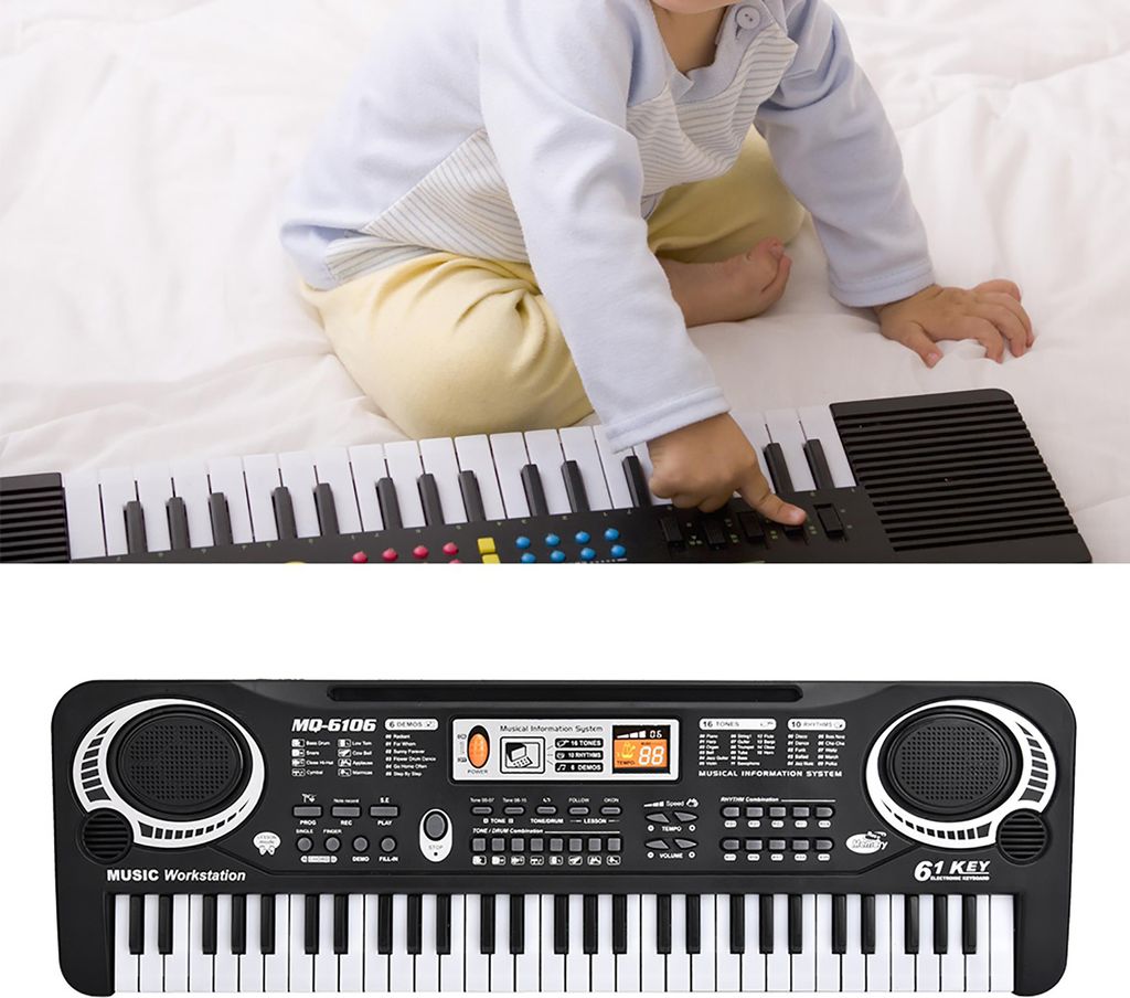 A child is playing with a keyboard.