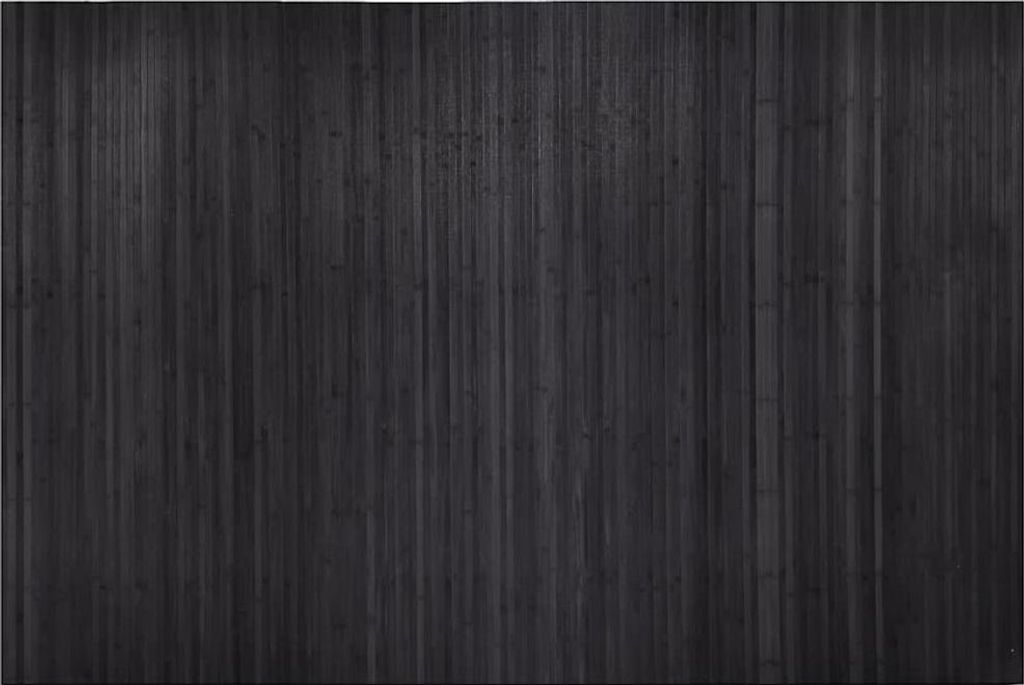 A full shot of a grey bamboo room divider.