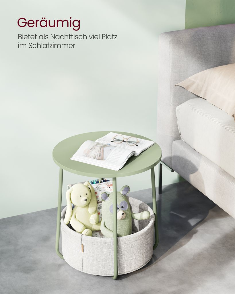 A round side table with a storage basket underneath, placed next to a bed.