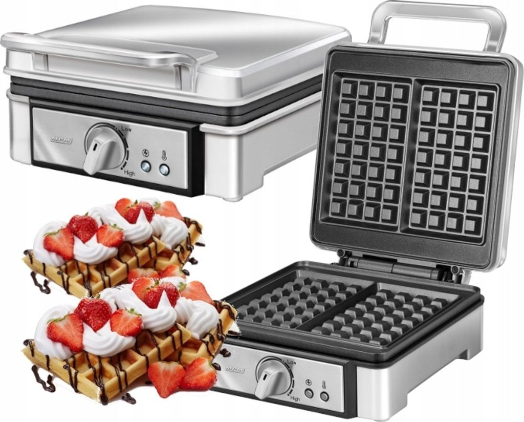 A waffle maker with two waffles topped with whipped cream and strawberries.