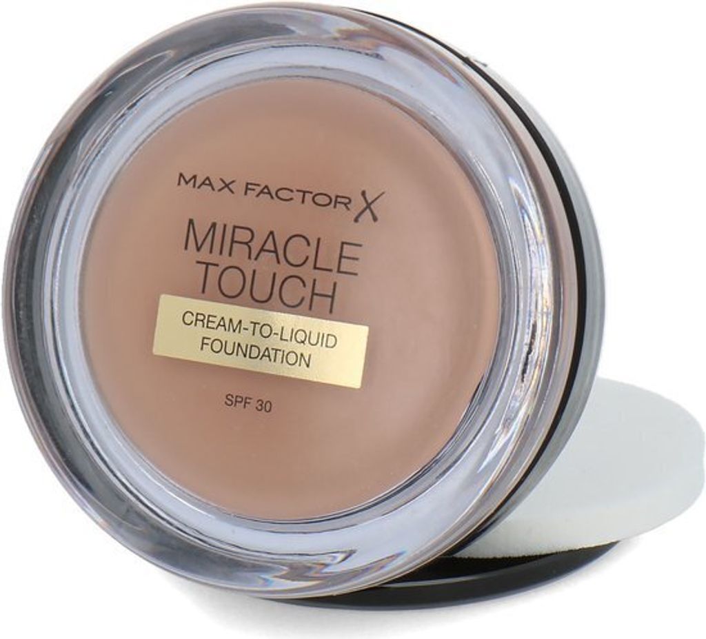 A close-up, slightly angled view of a Max Factor Miracle Touch foundation compact.