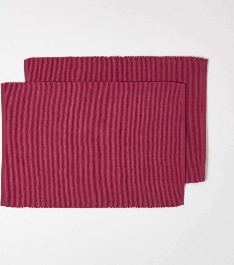 Two red placemats are arranged on a white background.