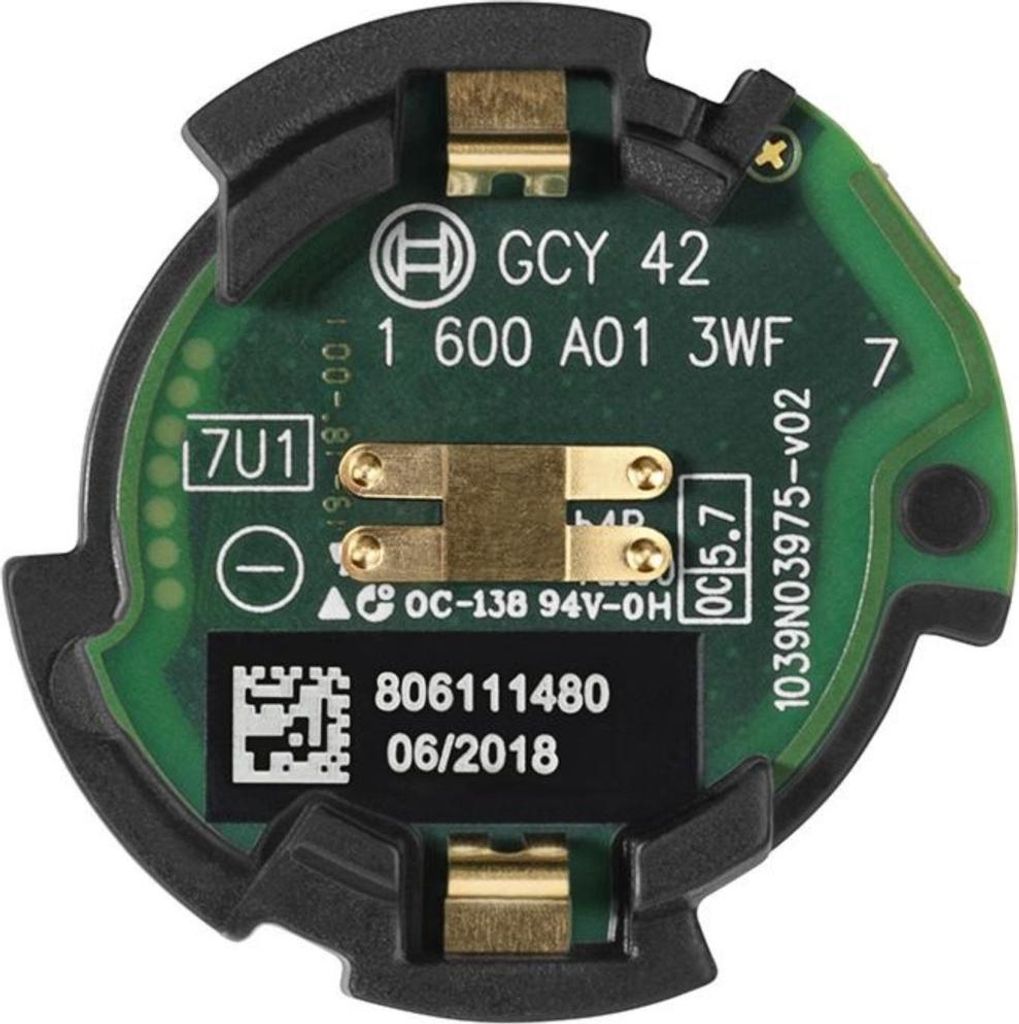 A close-up view of a green circuit board with electronic components and text labels.