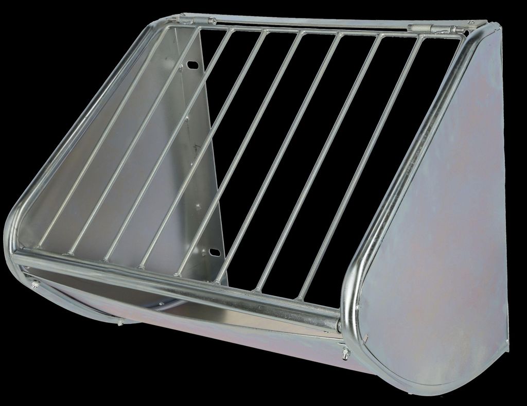 A metal hay feeder for animals, mounted on a black background.