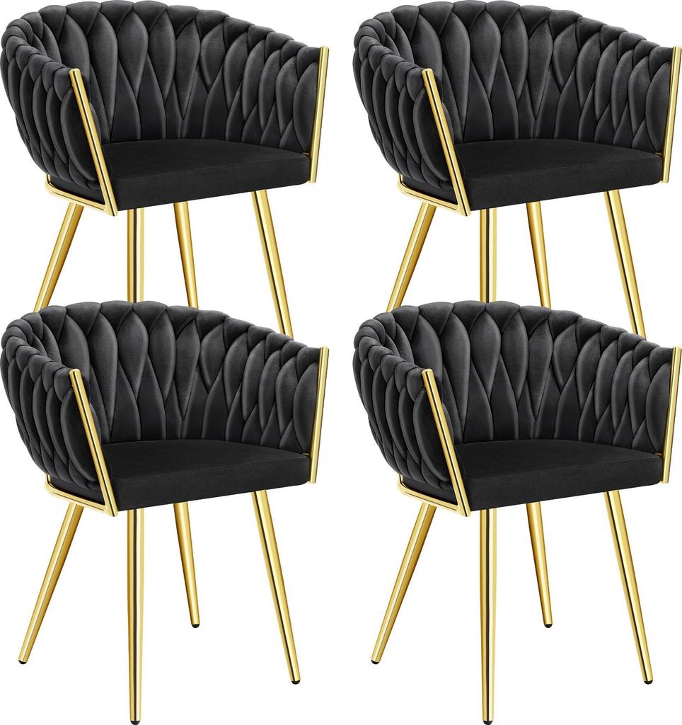 Four black velvet dining chairs with gold legs are arranged in a 2x2 grid against a white background.