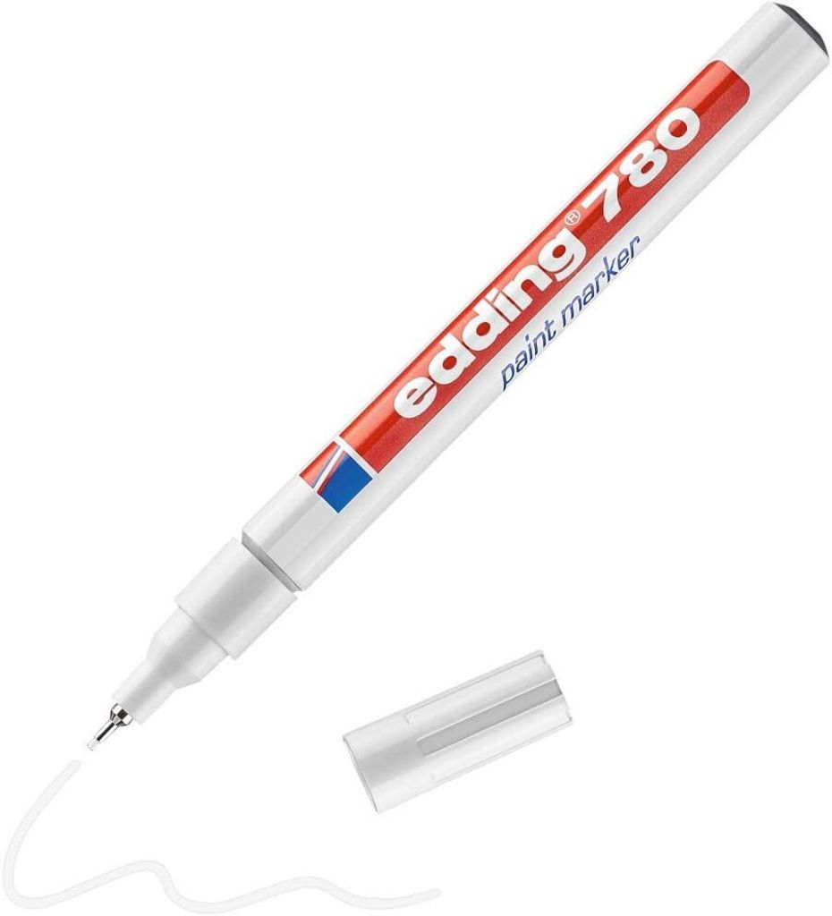 A white Edding 780 paint marker with a red and blue logo is shown on a white background, with its cap off and a white line drawn on the surface.