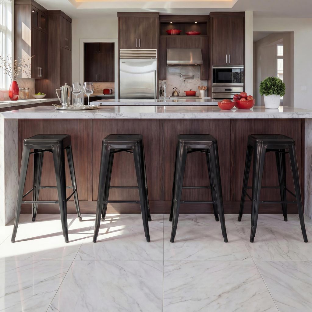 A modern kitchen island with four black metal bar stools.