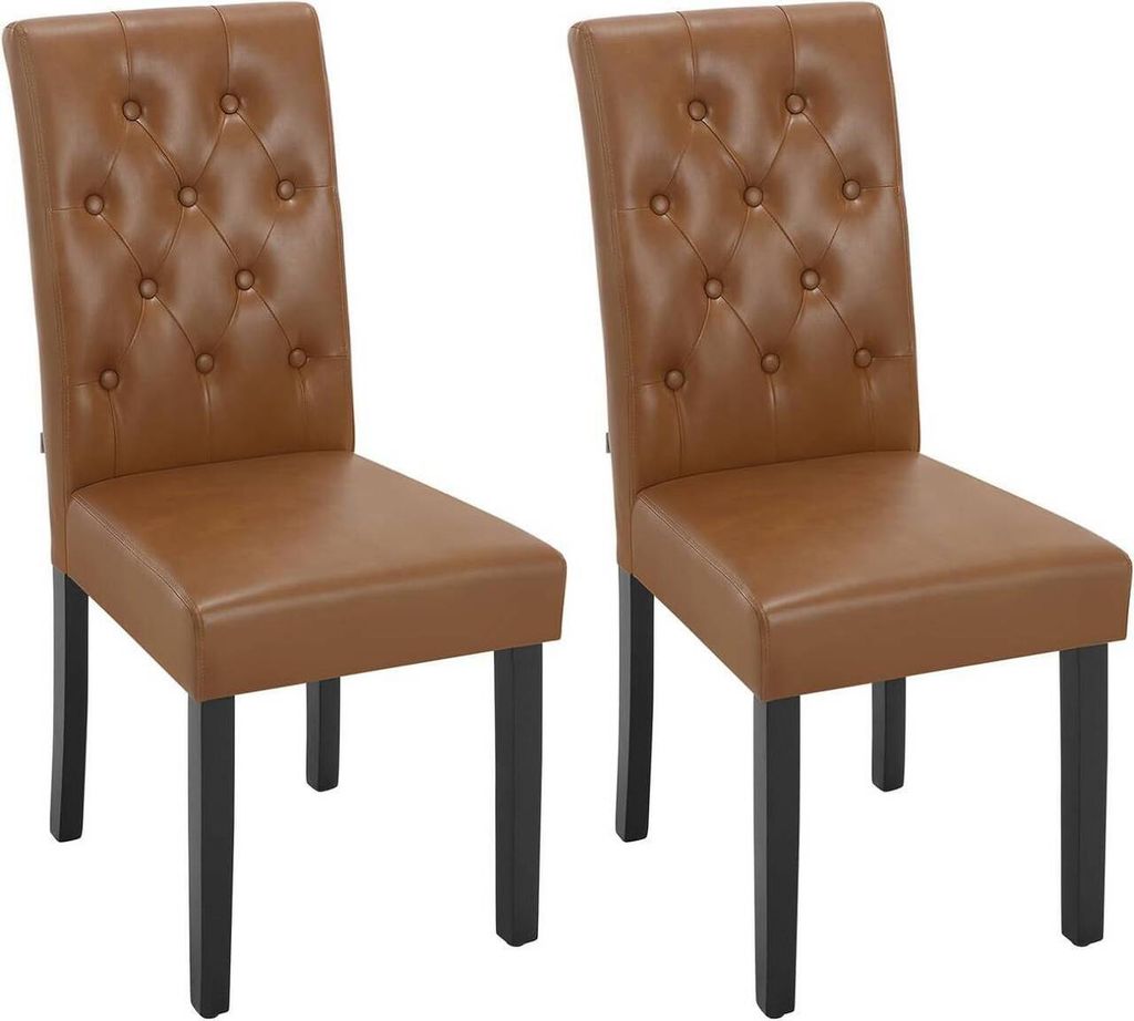 Two brown faux leather dining chairs with tufted backs and black wooden legs are shown against a white background.