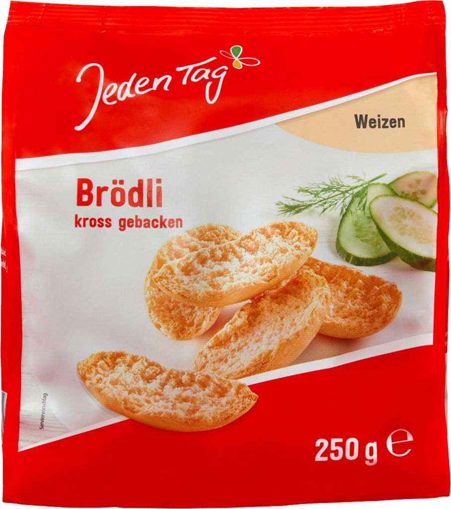 A red and white package of 'Jeden Tag Brödli Weizen' with images of the product and some cucumber slices and dill.