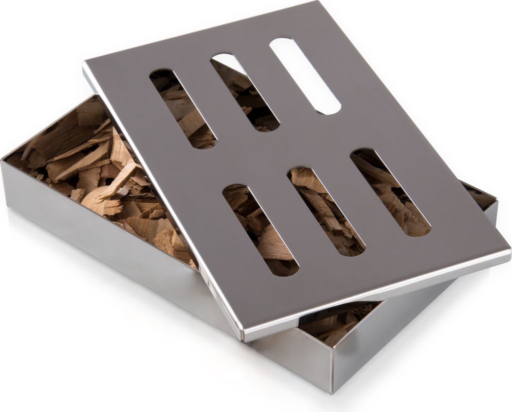 A stainless steel smoker box filled with wood chips, with its lid slightly ajar.