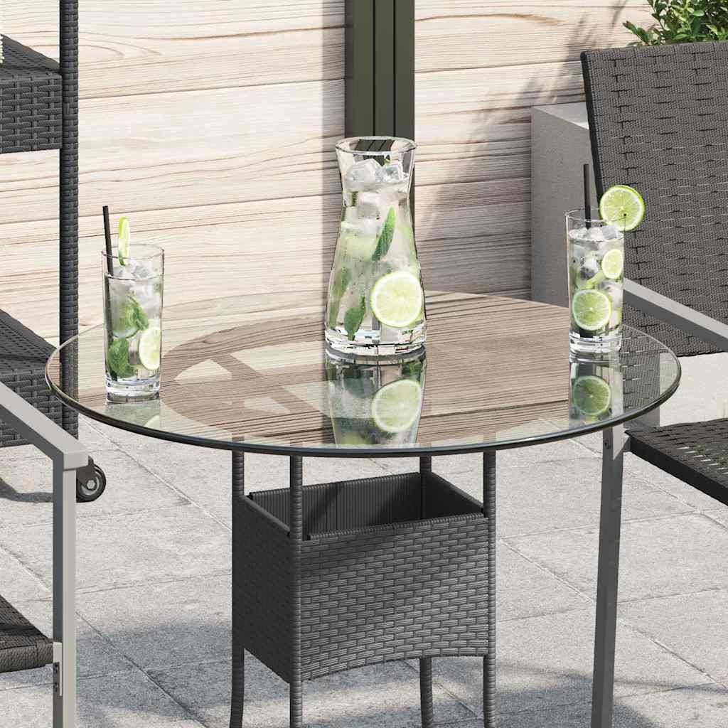 A round glass tabletop with a wicker planter underneath, set on an outdoor patio with drinks on the table.