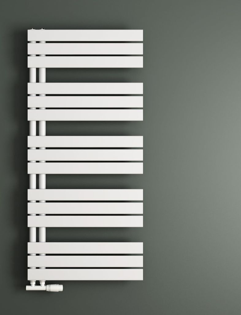 A white radiator is mounted on a gray wall.