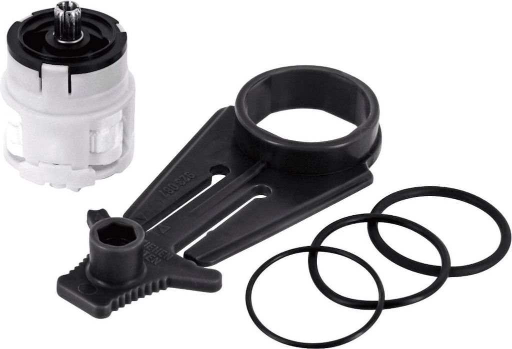 A faucet cartridge and associated parts are laid out on a white background.