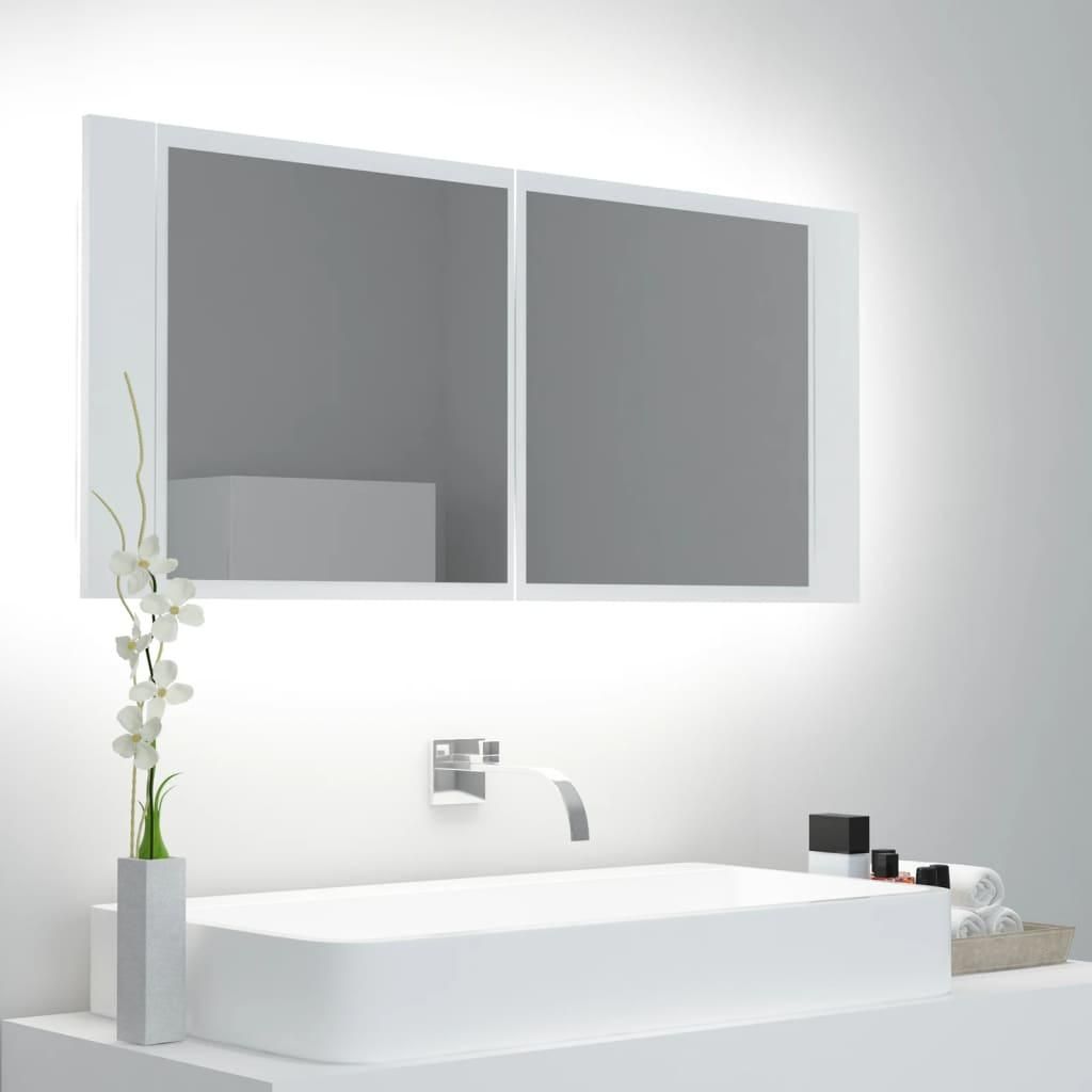 A modern bathroom vanity with a sink, faucet, and a lighted medicine cabinet.