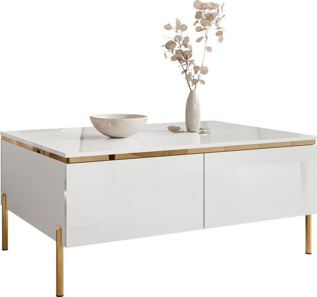 A white, high-gloss coffee table with gold legs and trim, decorated with a bowl and a vase with dried flowers.