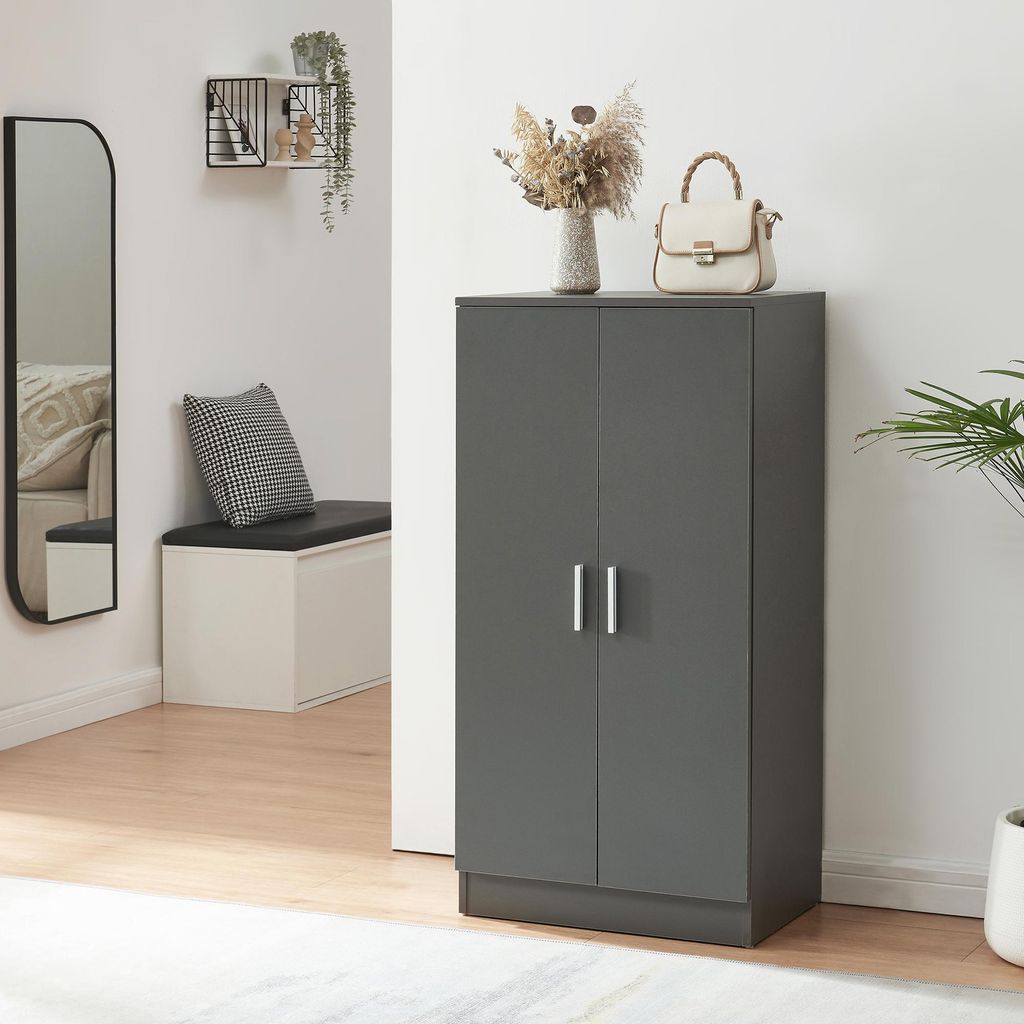 A hallway with a shoe cabinet, mirror, and bench.