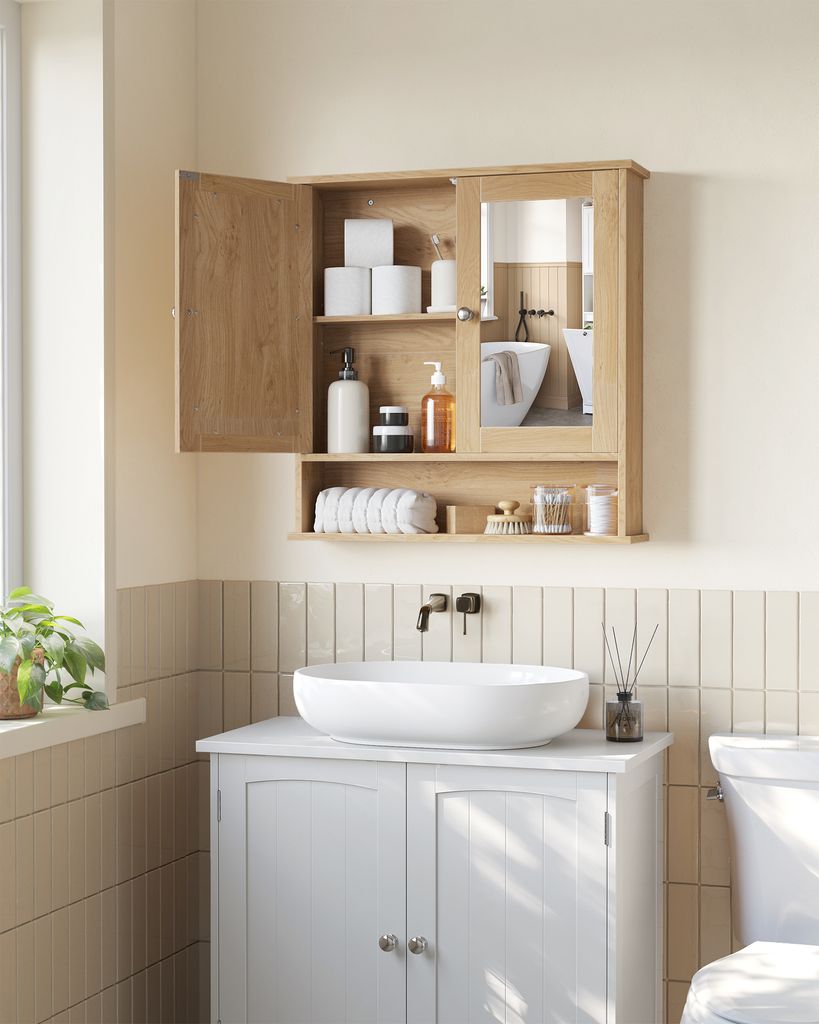 A bathroom scene featuring a wooden medicine cabinet with a mirror, a white sink, and a vanity.