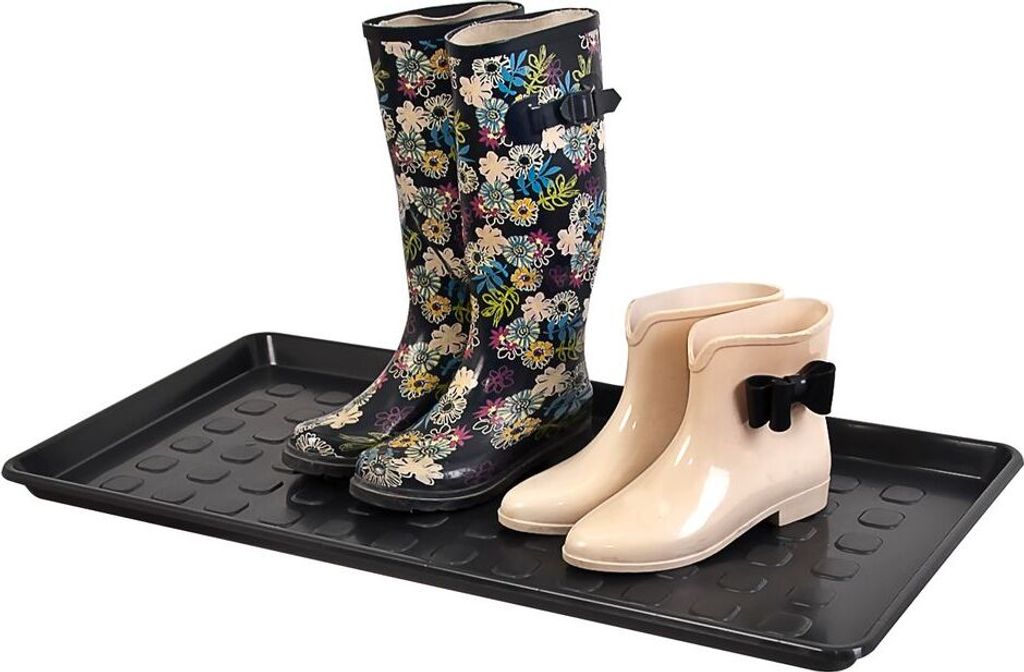 A boot tray with two pairs of boots on it.