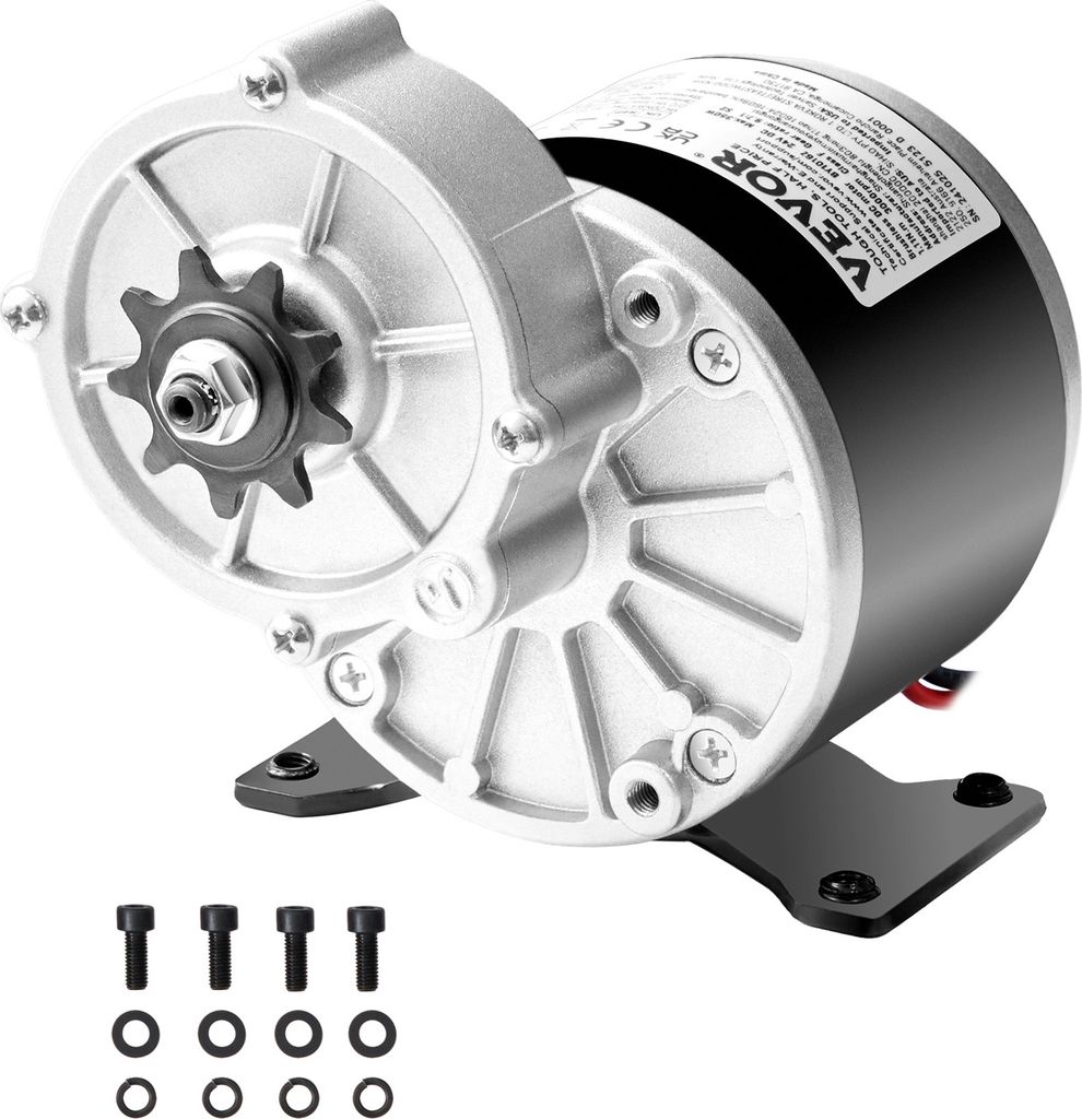 A silver and black electric DC motor with a sprocket attached, shown on a white background. Several screws and washers are laid out in the foreground.