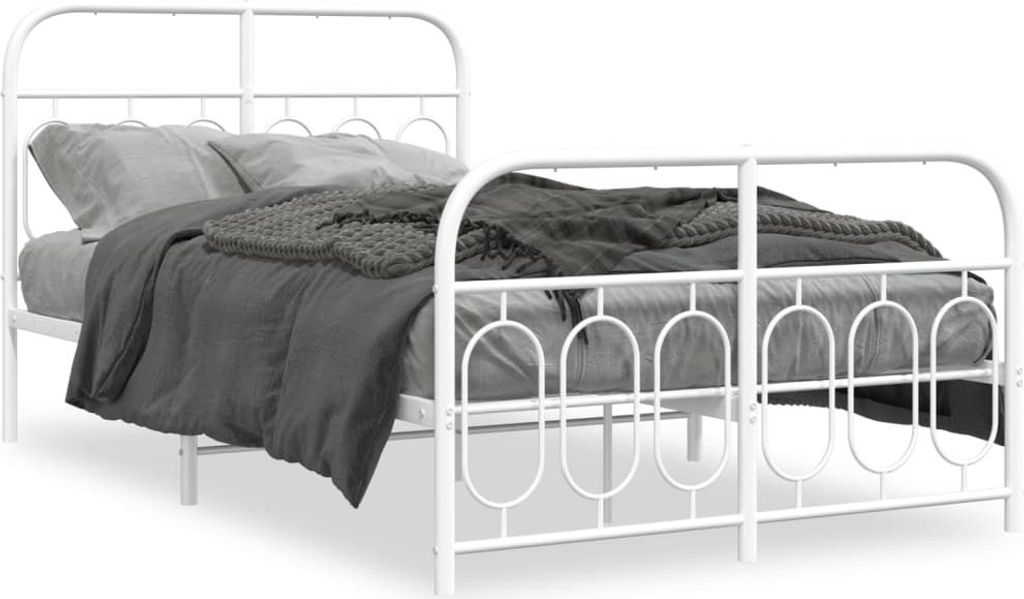 A white metal bed frame with bedding.