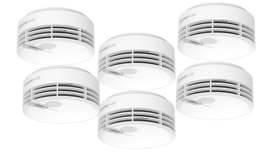 A group of six white smoke detectors are arranged in a staggered formation against a white background.