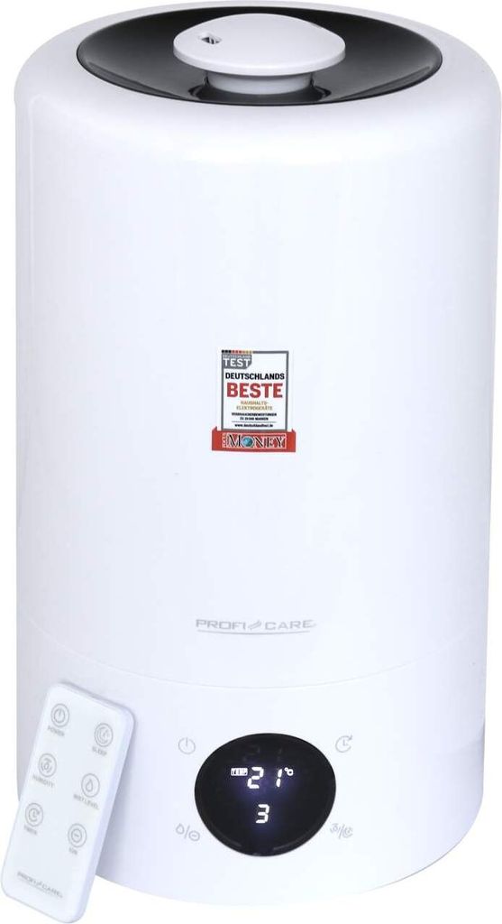 A white humidifier with a black top and a remote control in front of it. A digital display shows '21' and '3'. There is a seal of 'TEST DEUTSCHLANDS BESTE' on the front.
