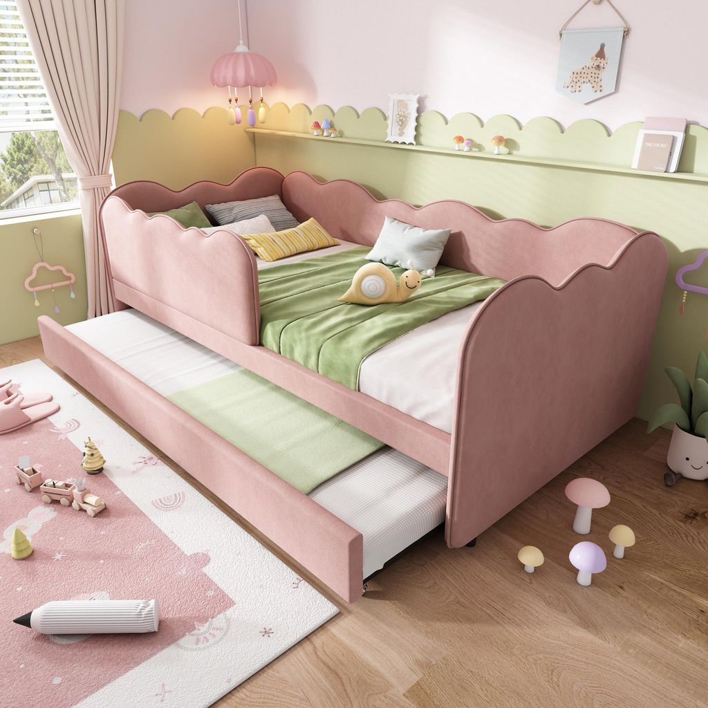A child's bedroom with a pink daybed and pull-out trundle, decorated with playful elements.