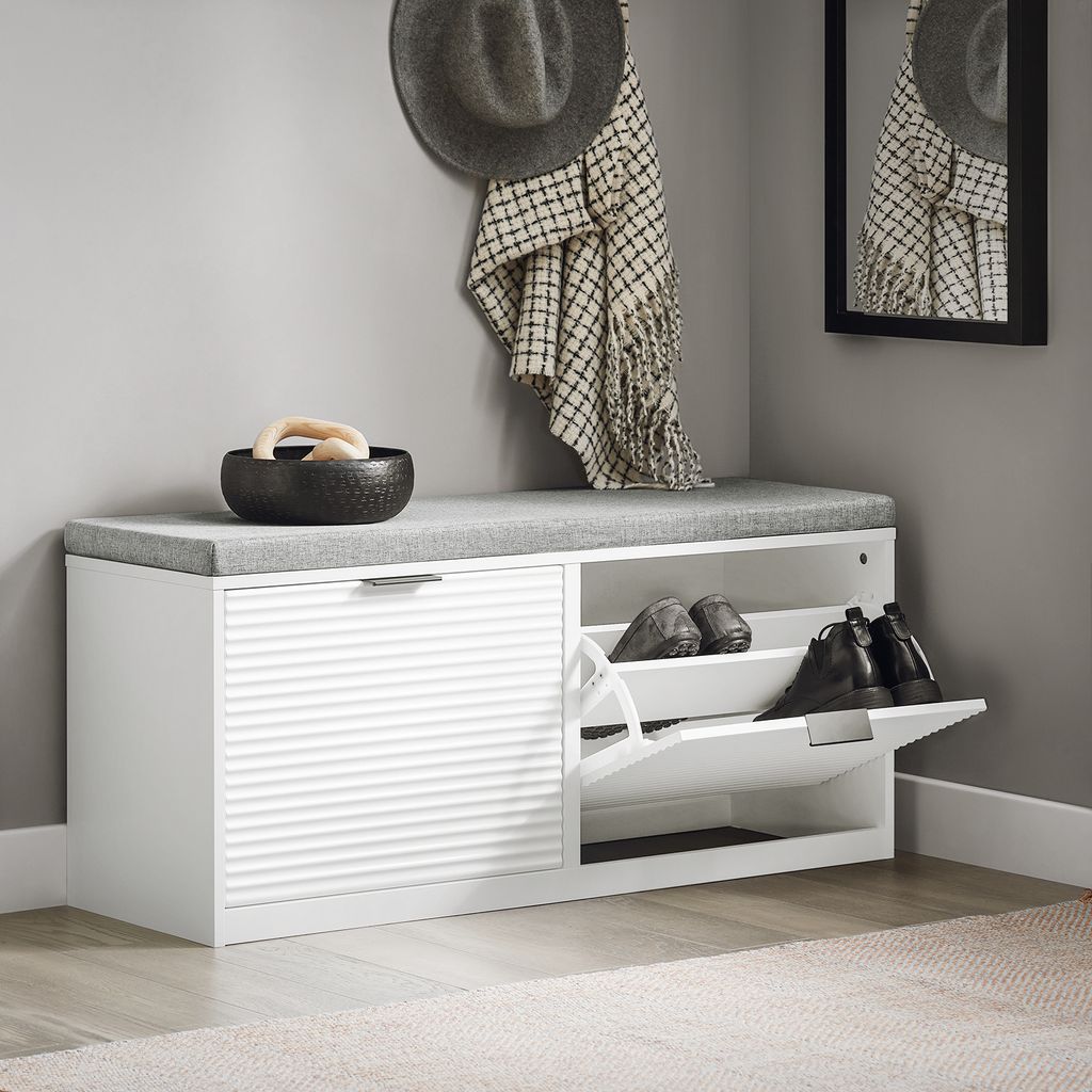 A hallway or entryway with a shoe cabinet and bench.