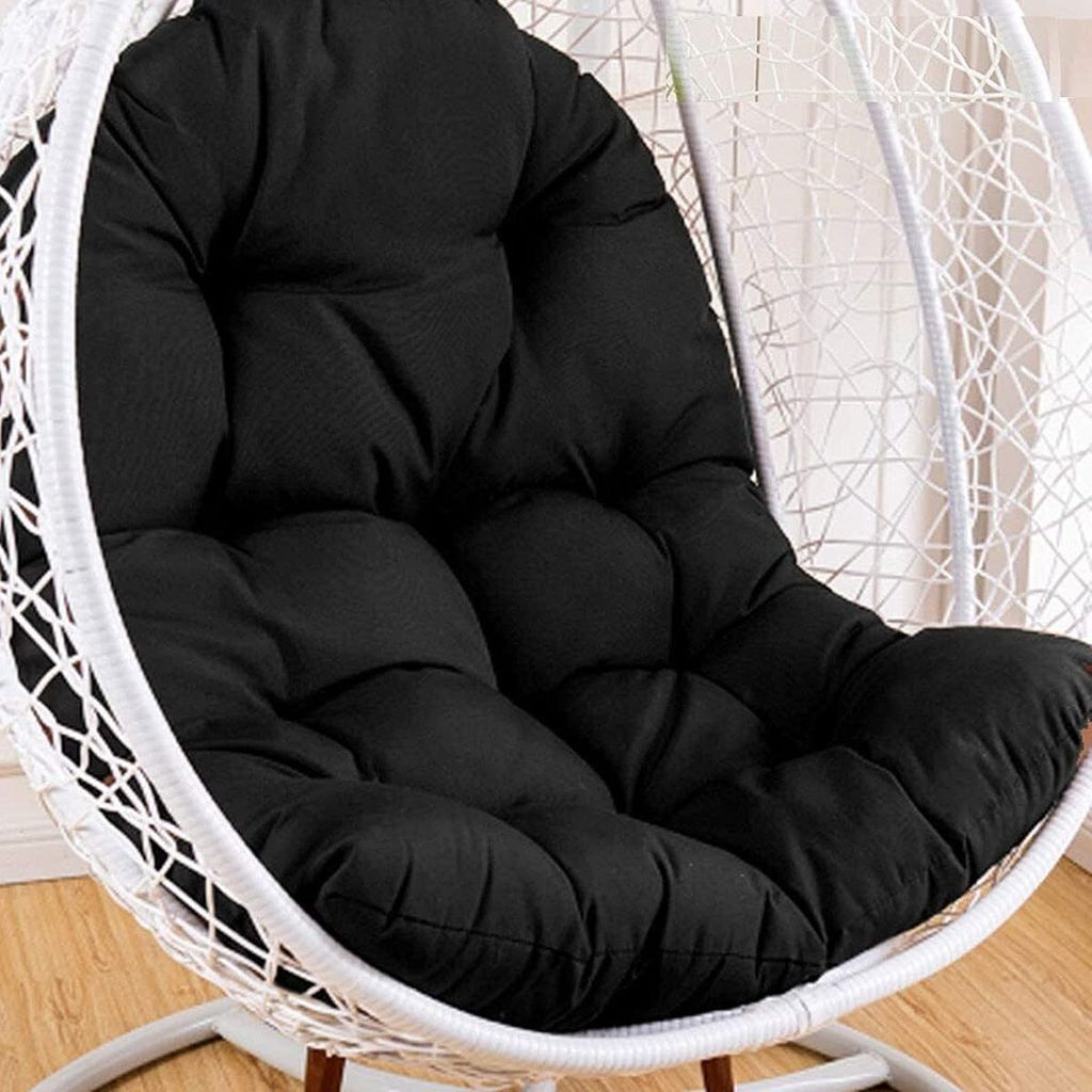 A close-up of a black cushion inside a white hanging chair.