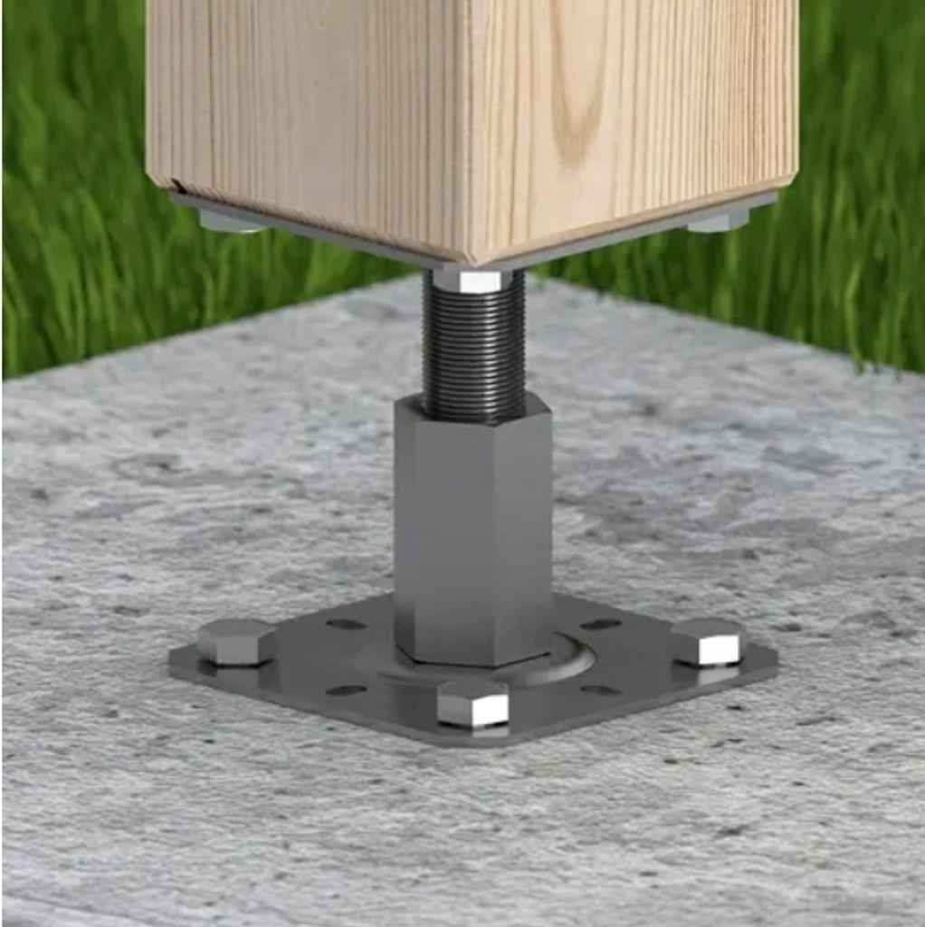 A close-up view of a metal post anchor securing a wooden post to a concrete surface, with grass in the background.