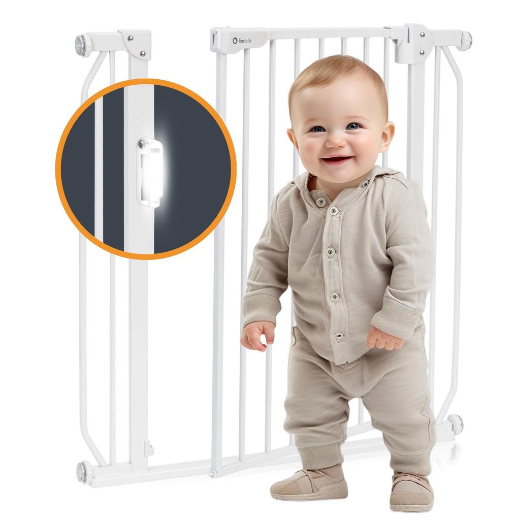 A baby is standing in front of a white baby gate. A close-up inset shows a detail of the gate's locking mechanism.