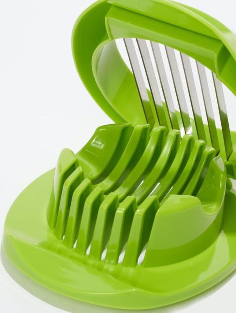 A close-up of a green egg slicer.