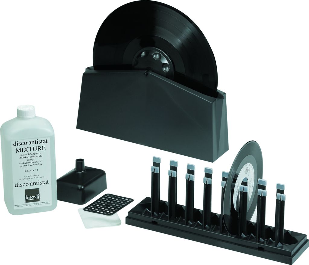 A set of vinyl record cleaning accessories, including a cleaning machine, solution, and drying rack, displayed against a white background.
